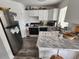 Efficient kitchen featuring stainless steel refrigerator, marble countertops, and ample white cabinetry at 4158 Tamiami Trl # U4, Port Charlotte, FL 33952