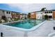 Community swimming pool with clear water and surrounding apartment buildings on a sunny day at 4158 Tamiami Trl # U4, Port Charlotte, FL 33952