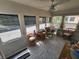 Bright sunroom with multiple windows offering outdoor views, comfortable seating, and tiled flooring at 4158 Tamiami Trl # U4, Port Charlotte, FL 33952
