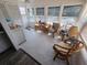 Relaxing sunroom filled with light from numerous windows and featuring comfortable wicker seating at 4158 Tamiami Trl # U4, Port Charlotte, FL 33952