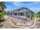 Exterior view of a screened-in lanai with pool and landscaped yard at 421 Strasburg Dr, Port Charlotte, FL 33954