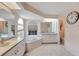 Bright bathroom features a soaking tub, white cabinets, and modern fixtures at 421 Strasburg Dr, Port Charlotte, FL 33954