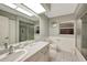 Bathroom with gray tile floor, shower, toilet and a large mirror over the vanity at 421 Strasburg Dr, Port Charlotte, FL 33954