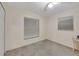 Bright bedroom features neutral carpet, a ceiling fan, and two windows at 421 Strasburg Dr, Port Charlotte, FL 33954