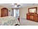 Bedroom with neutral carpet, beautiful wood furniture, and sheer curtains at 421 Strasburg Dr, Port Charlotte, FL 33954