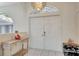 Bright entryway with double doors, tiled floor, decorative statue, and stylish furnishings enhance the home's character at 421 Strasburg Dr, Port Charlotte, FL 33954