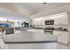 Modern kitchen featuring stainless steel appliances and light cabinetry, seamlessly connected to the living room at 421 Strasburg Dr, Port Charlotte, FL 33954