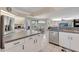 Open kitchen design with an island bar, stainless steel appliances, and seamless access to the adjacent living space at 421 Strasburg Dr, Port Charlotte, FL 33954
