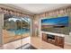 Bright room with pool view and lanai access features modern entertainment center and beach scene TV display at 421 Strasburg Dr, Port Charlotte, FL 33954