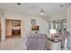 Bright living room showcases neutral paint, tiled floors, sliding glass doors, and cozy furniture at 421 Strasburg Dr, Port Charlotte, FL 33954