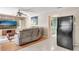 Bright living room features wood floors, neutral paint, modern furnishings, and adjacent bathroom at 421 Strasburg Dr, Port Charlotte, FL 33954