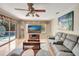 Inviting living room featuring wood floors, neutral paint, modern furnishings, and a view of pool at 421 Strasburg Dr, Port Charlotte, FL 33954