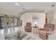 Bright living room boasts tiled floors, neutral paint, and large sliding glass doors at 421 Strasburg Dr, Port Charlotte, FL 33954