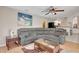 Comfortable living room with a plush gray sectional sofa, creating an inviting space for relaxation and entertainment at 421 Strasburg Dr, Port Charlotte, FL 33954
