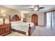 Classic bedroom features neutral paint, fan, wooden furniture, and a side window at 421 Strasburg Dr, Port Charlotte, FL 33954