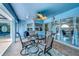 Comfortable covered patio features a ceiling fan and an outdoor dining set at 421 Strasburg Dr, Port Charlotte, FL 33954
