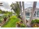 Lush backyard showcasing palm trees, landscaping, and screened pool area at 4268 Leesburg Ave, North Port, FL 34288