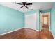 Bright bedroom with light blue walls, wood floors, ceiling fan and a closet at 4268 Leesburg Ave, North Port, FL 34288
