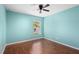 Light-filled bedroom with wood floors, and a view from the window at 4268 Leesburg Ave, North Port, FL 34288