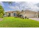 A well-maintained front lawn, with a tidy one-story home and attached garage at 4268 Leesburg Ave, North Port, FL 34288