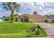 Inviting home featuring a lush lawn, palm trees and a charming exterior at 4268 Leesburg Ave, North Port, FL 34288