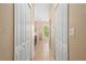 Hallway leading to a bathroom with multiple storage closets along the wall at 4268 Leesburg Ave, North Port, FL 34288