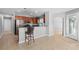 Open kitchen featuring stainless steel appliances, breakfast bar, and modern countertops at 4268 Leesburg Ave, North Port, FL 34288