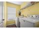 Bright laundry room with a washer, dryer, and a utility sink at 4268 Leesburg Ave, North Port, FL 34288