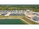 New construction homes feature screened pools and lake views in this sunny aerial of the residential community at 42771 Valley Brooks St, Punta Gorda, FL 33982