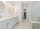 Bathroom with double vanity, large mirrors, and walk-in shower at 42771 Valley Brooks St, Punta Gorda, FL 33982