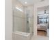 Elegant walk-in shower with neutral tile and glass surround, located adjacent to bedroom at 42771 Valley Brooks St, Punta Gorda, FL 33982