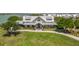 The clubhouse features a covered porch, lakeside views, and a beautifully landscaped lawn at 42771 Valley Brooks St, Punta Gorda, FL 33982
