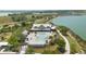 Aerial view of the pool with ample seating, surrounded by lush greenery, with a lake visible in the background at 42771 Valley Brooks St, Punta Gorda, FL 33982