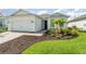 Charming home with a 2-car garage, landscaped yard, and inviting entryway at 42771 Valley Brooks St, Punta Gorda, FL 33982