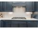 Close-up of the modern kitchen featuring stainless steel gas range and subway tile backsplash at 42771 Valley Brooks St, Punta Gorda, FL 33982