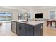 Open kitchen with island flows into the living area, offering views of the pool at 42771 Valley Brooks St, Punta Gorda, FL 33982