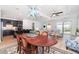 Bright living room featuring an open floorplan, dark blue kitchen island, and chandelier at 42771 Valley Brooks St, Punta Gorda, FL 33982