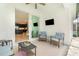 Covered patio with comfortable seating and a view of the kitchen through sliding glass doors at 42771 Valley Brooks St, Punta Gorda, FL 33982