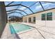 A refreshing swimming pool is surrounded by a screened enclosure and a stylish patio at 42771 Valley Brooks St, Punta Gorda, FL 33982
