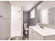 A clean and modern bathroom featuring a walk-in shower with a white toilet and vanity at 4371 Guard St, Punta Gorda, FL 33980