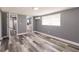 A simple bedroom design with minimalist decor that features wood-look flooring and neutral gray walls at 4371 Guard St, Punta Gorda, FL 33980