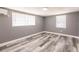 A simple bedroom design with minimalist decor that features wood-look flooring and neutral gray walls at 4371 Guard St, Punta Gorda, FL 33980
