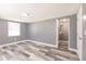 A simple bedroom design with minimalist decor that features wood-look flooring, closet, and neutral gray walls at 4371 Guard St, Punta Gorda, FL 33980
