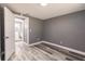 A simple bedroom design with minimalist decor that features wood-look flooring and neutral gray walls at 4371 Guard St, Punta Gorda, FL 33980