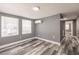 The bedroom features grey walls, wood-look flooring and two windows at 4371 Guard St, Punta Gorda, FL 33980