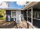 The exterior features grey painted siding, a white entry door and a screened patio at 4371 Guard St, Punta Gorda, FL 33980