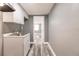 A utility sink featuring a modern faucet, sleek white cabinets, and wood-look floors provides functionality at 4371 Guard St, Punta Gorda, FL 33980