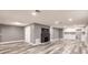 An open living room features grey walls, wood-look flooring, a fireplace, and a wet bar at 4371 Guard St, Punta Gorda, FL 33980