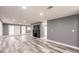 An open living room features grey walls, wood-look flooring, and a fireplace at 4371 Guard St, Punta Gorda, FL 33980