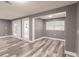 An open living room features grey walls, wood-look flooring, and double doors at 4371 Guard St, Punta Gorda, FL 33980